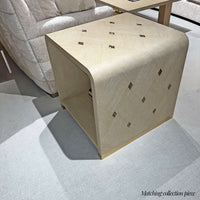Beige wood side table with diagonal inlays.