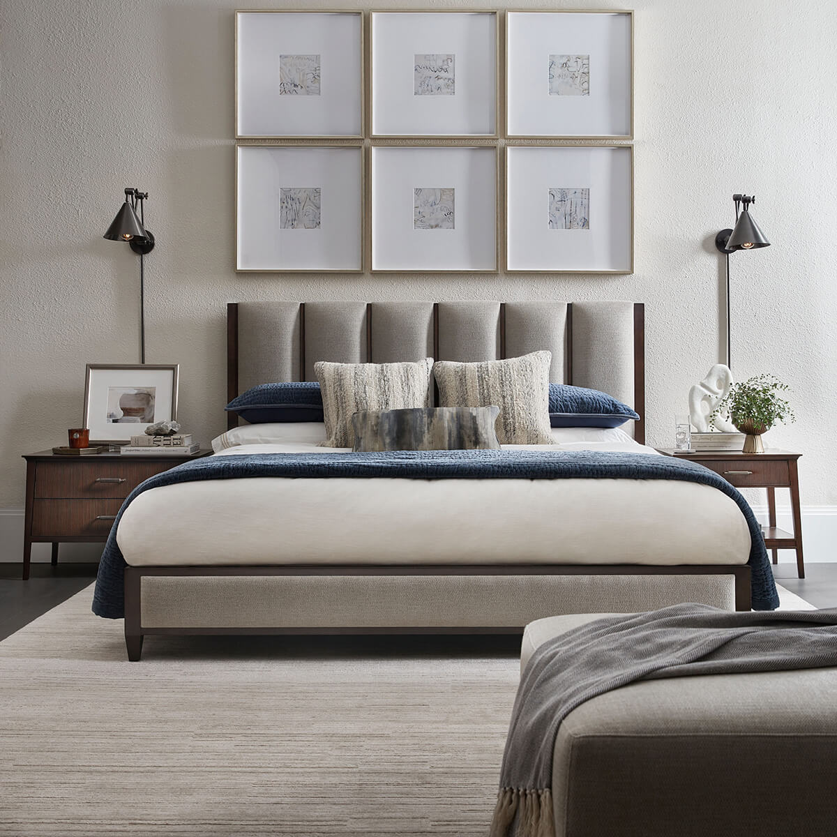 Bedroom with dark mid-century nightstands and modern decor.