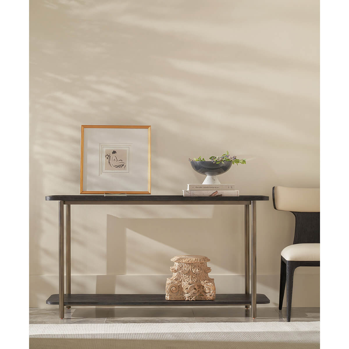 Dark oak console table in room setting, decorative items.