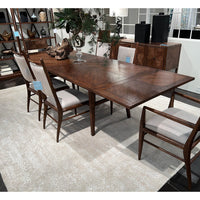 Close-up of dining table setup with chairs.
