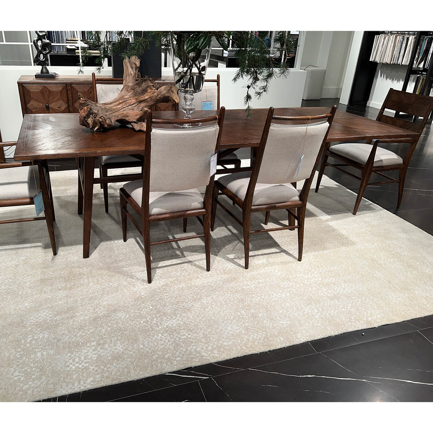 Extending dining table with chairs on a rug.