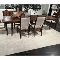 Extending dining table with chairs on a rug.
