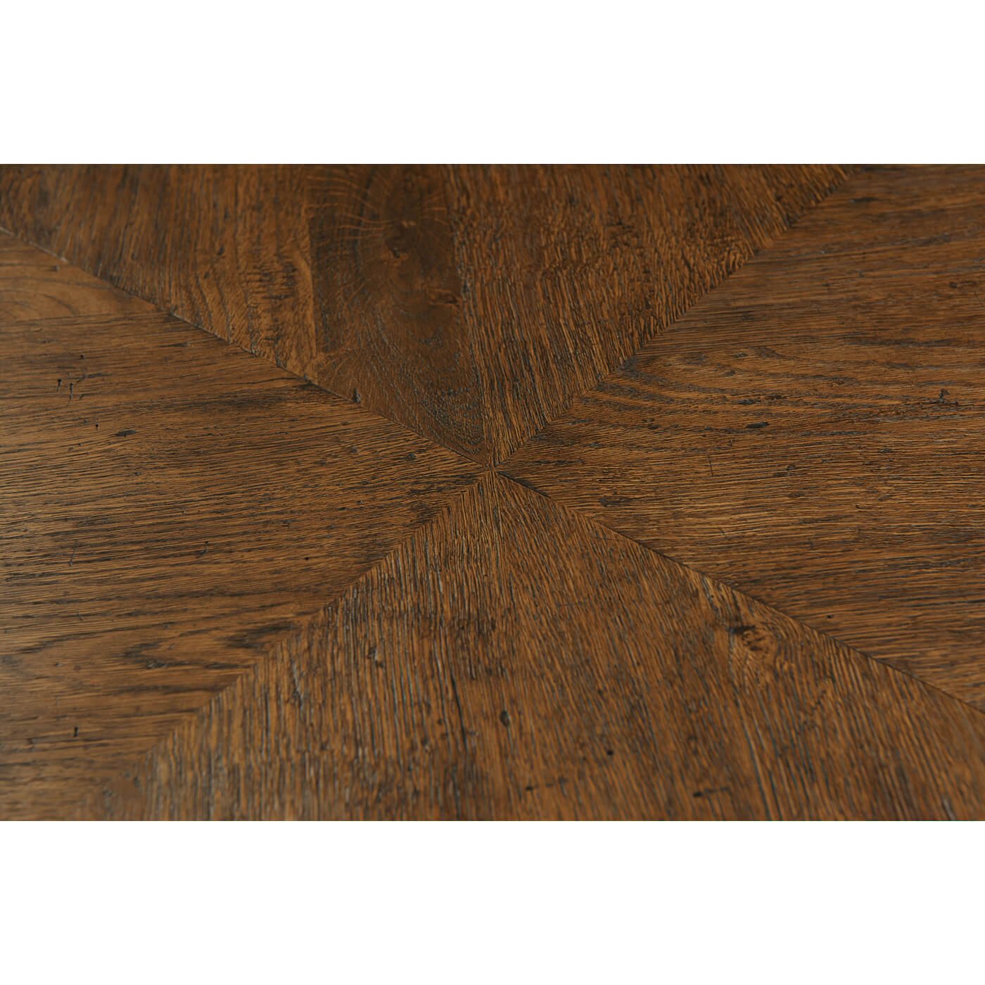 Dark oak parquetry detail on dining table surface.