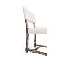 Close-up of chair's detailed wooden legs.