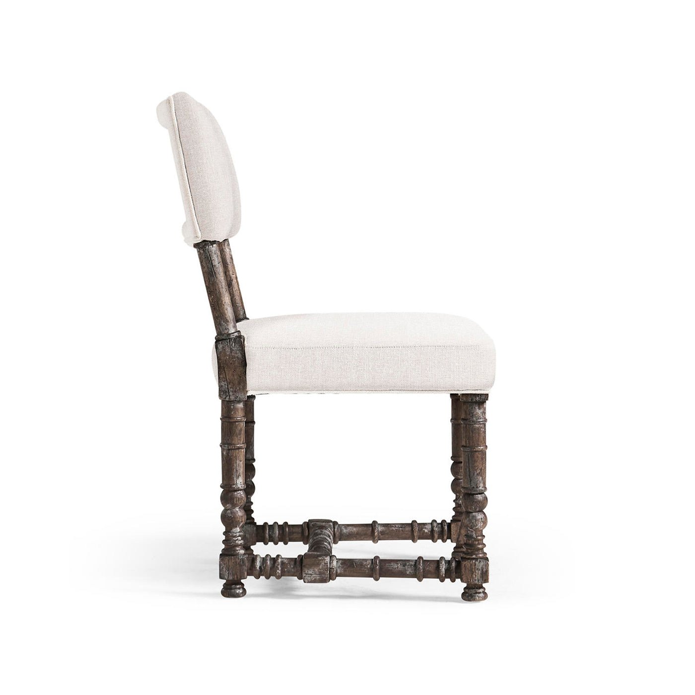 Side profile of spool-leg farmhouse chair.