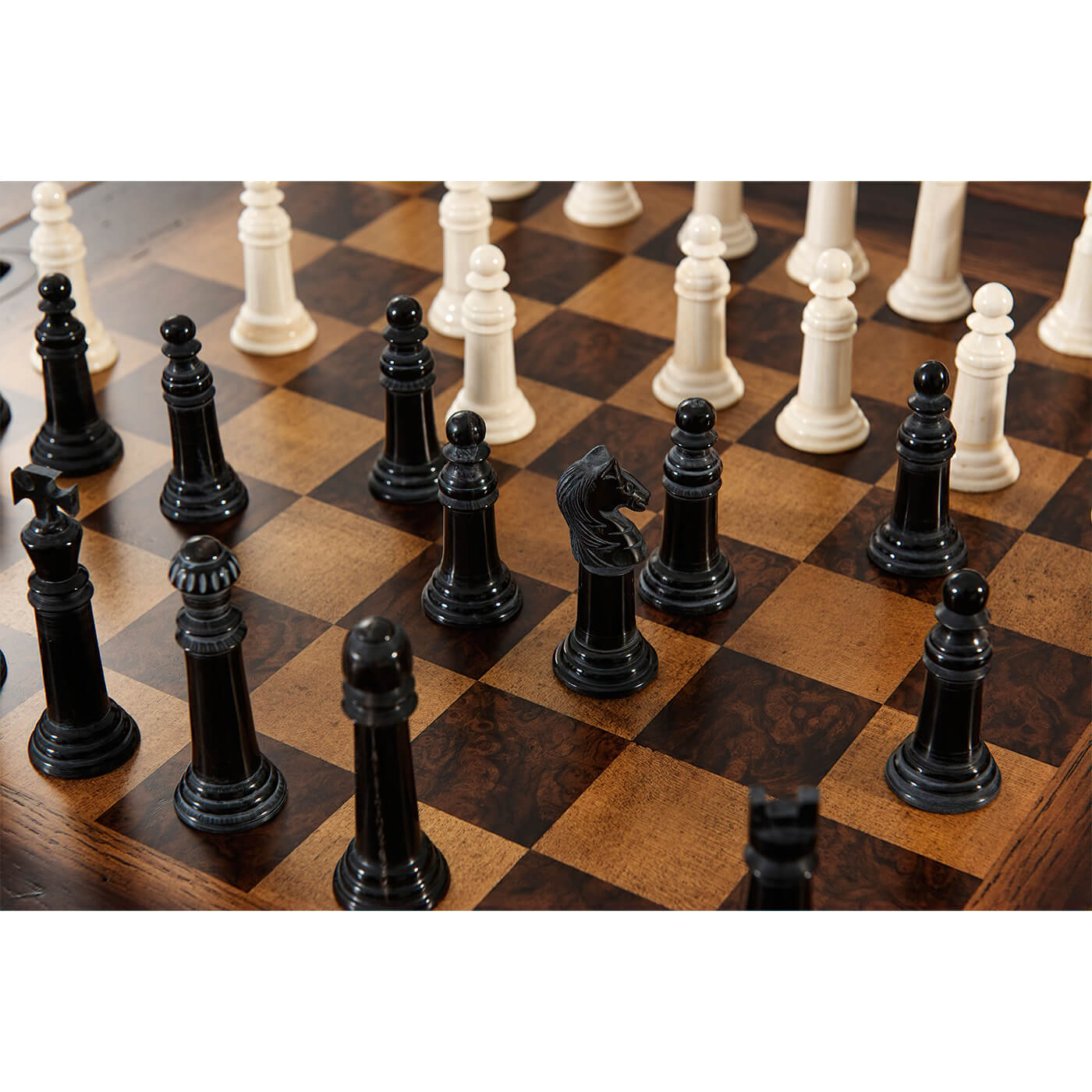 Close-up of chess pieces on game table.