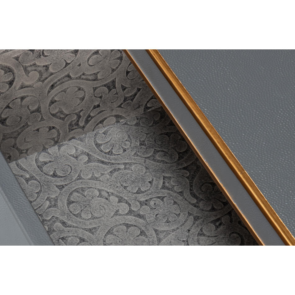 Detailed view of decorative drawer lining in nightstand.
