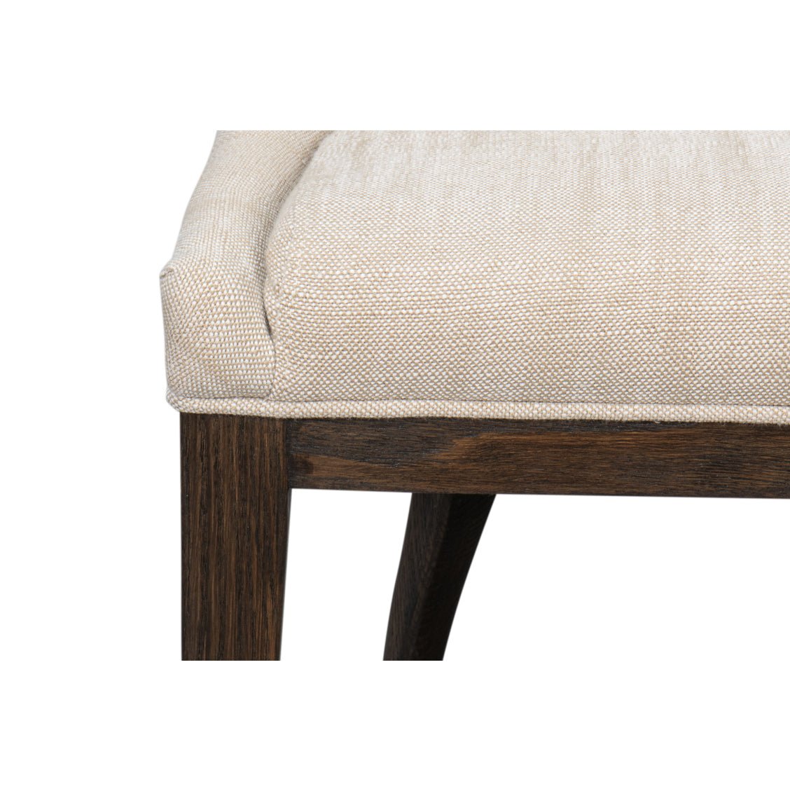 Close-up of beige upholstered dining chair seat edge.