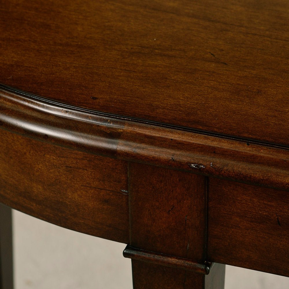 Dark wood console table surface detail close-up.