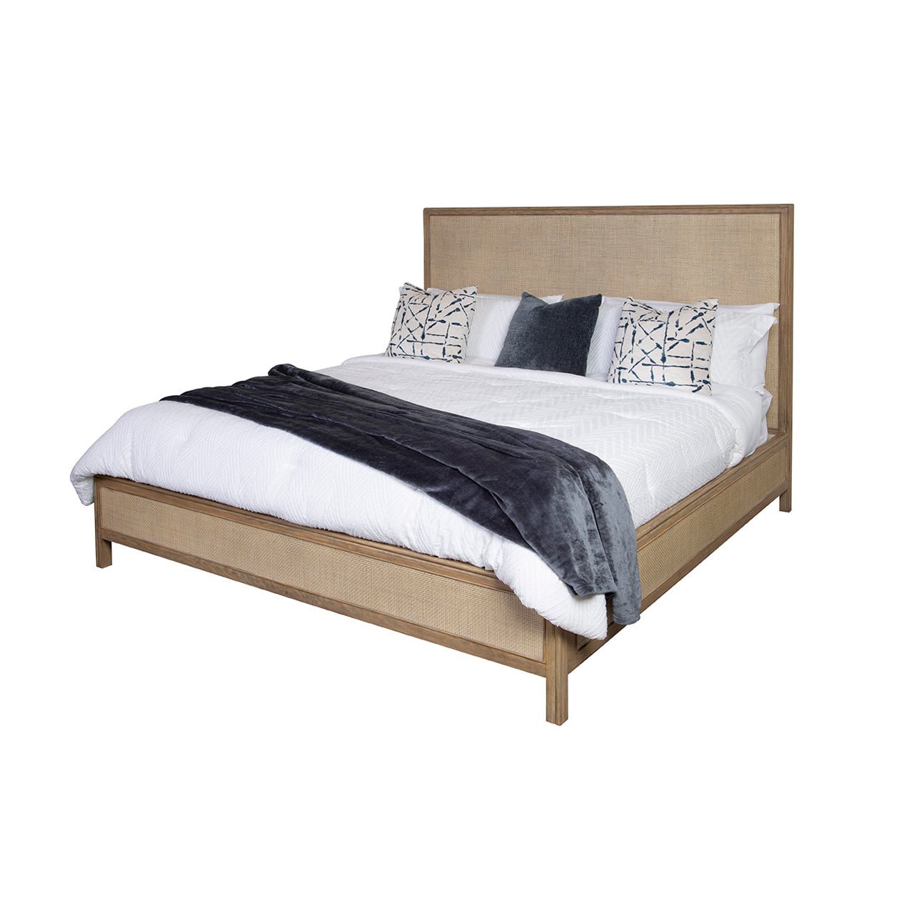 Modern bed with white bedding and decorative pillows.