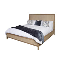 Modern bed with white bedding and decorative pillows.