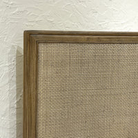 Close-up of bed's woven headboard detail.