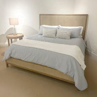 Bedroom with bed, side table, and lamp setup.