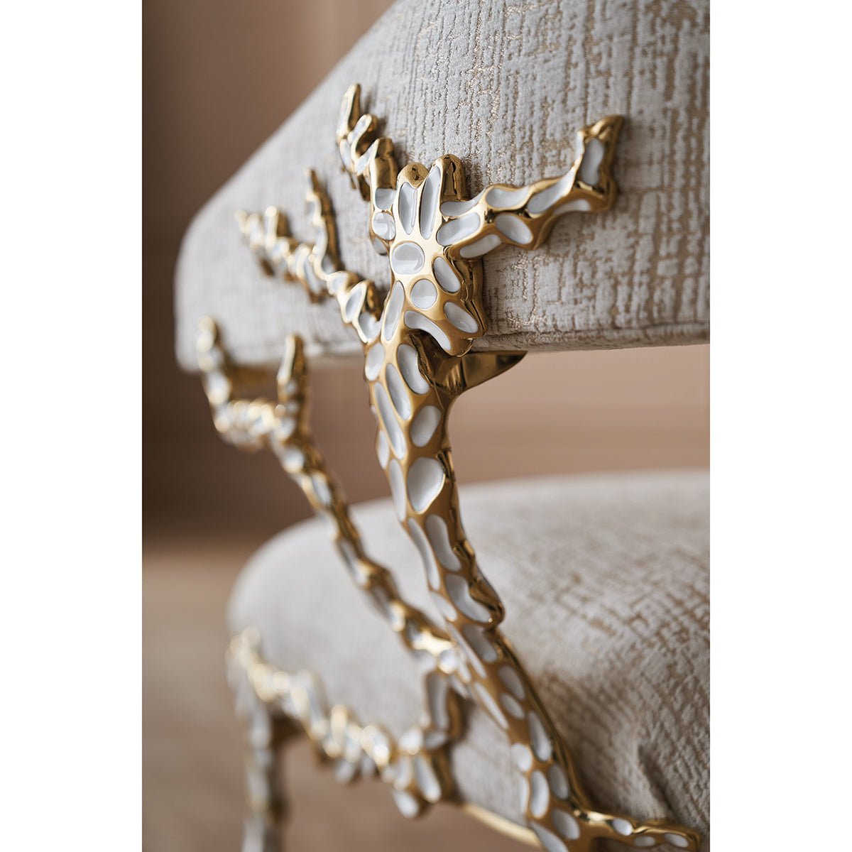 Close-up of accent chair frame, textured golden detail.