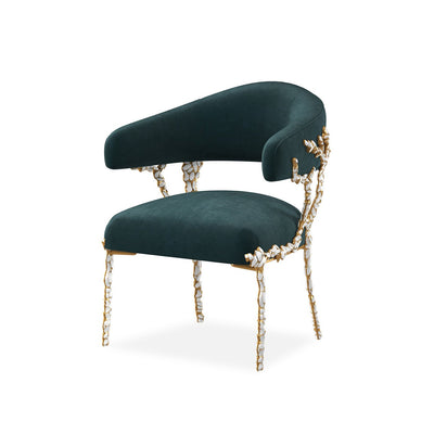 Modern blue velvet chair front view with artistic design.