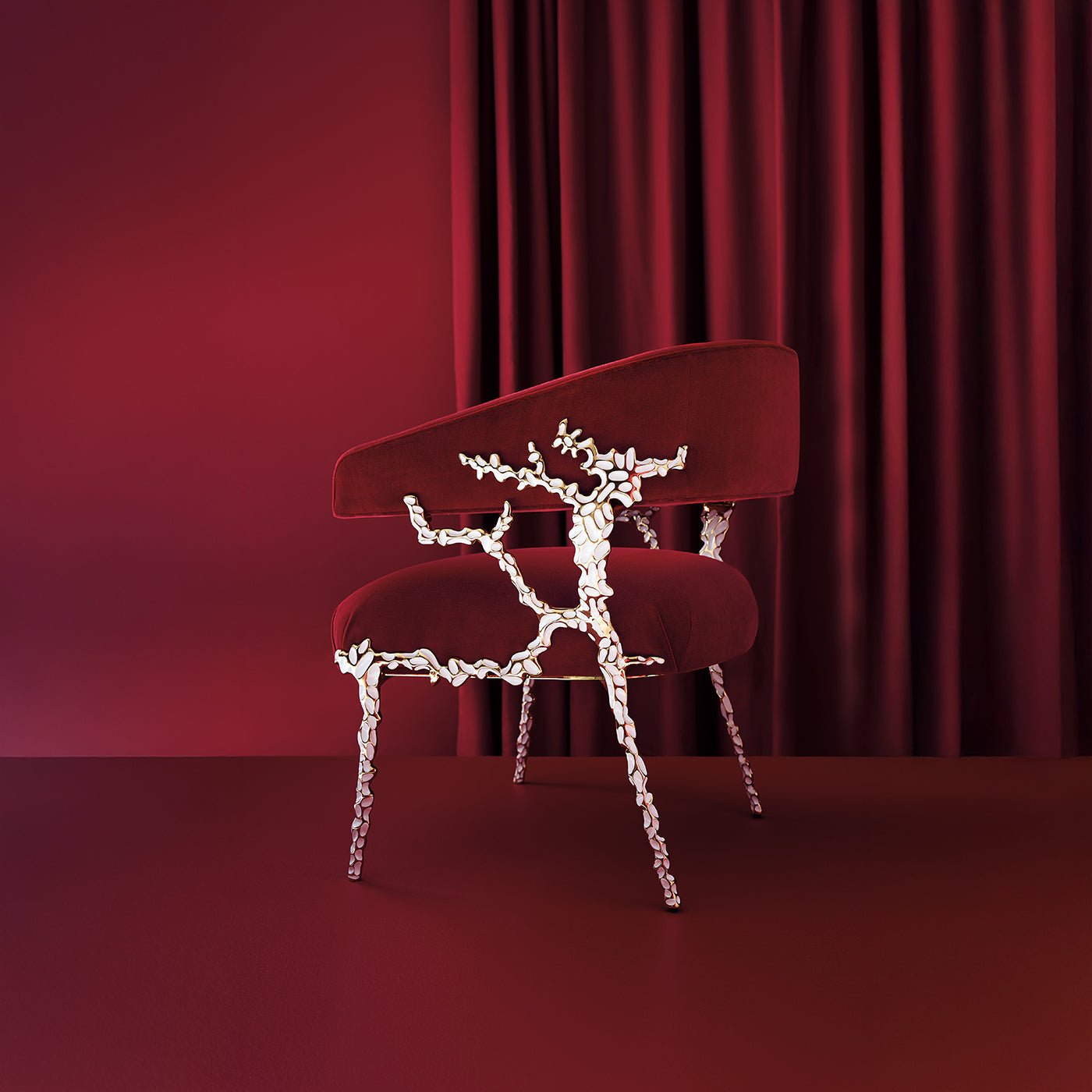 Elegant red chair against matching backdrop, artistic design.