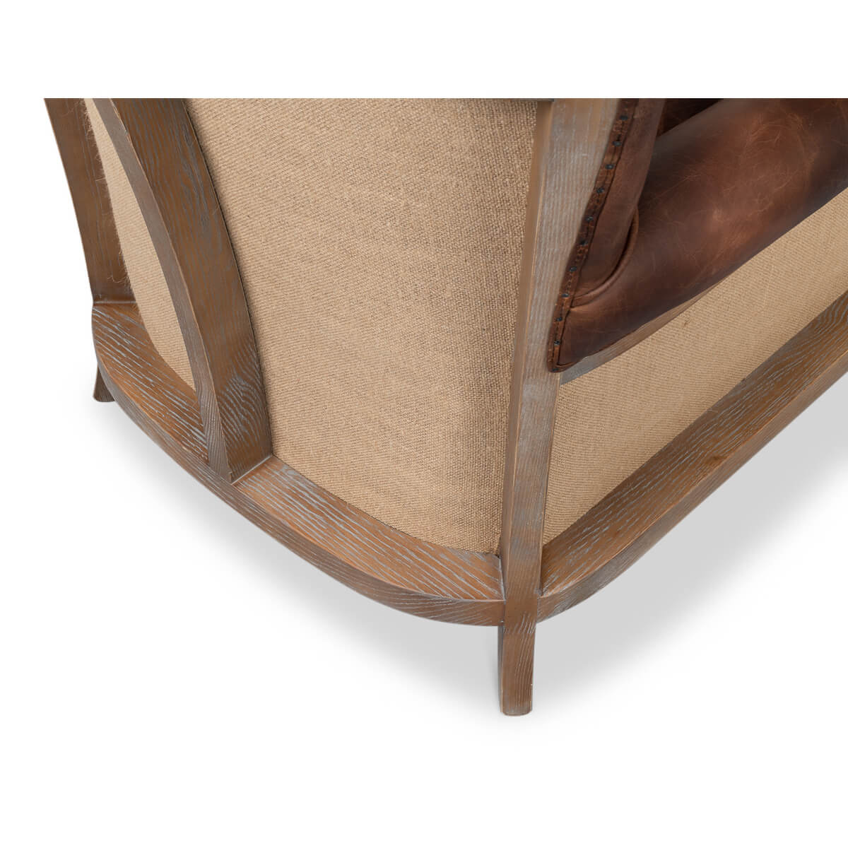 Base detail of club chair with wooden and fabric elements.