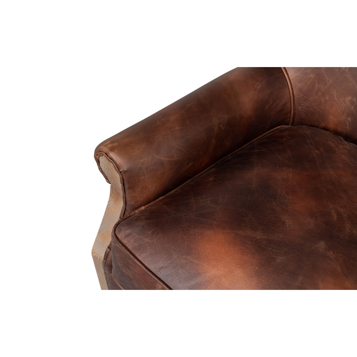 Close-up of leather armrest and cushion on club chair.