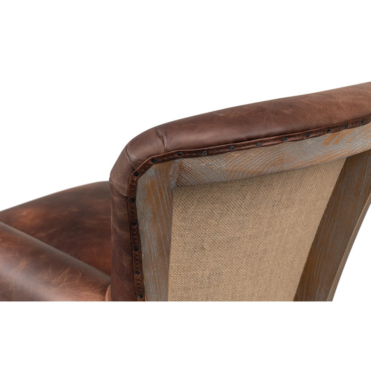 Back detail of leather chair with fabric and studs.