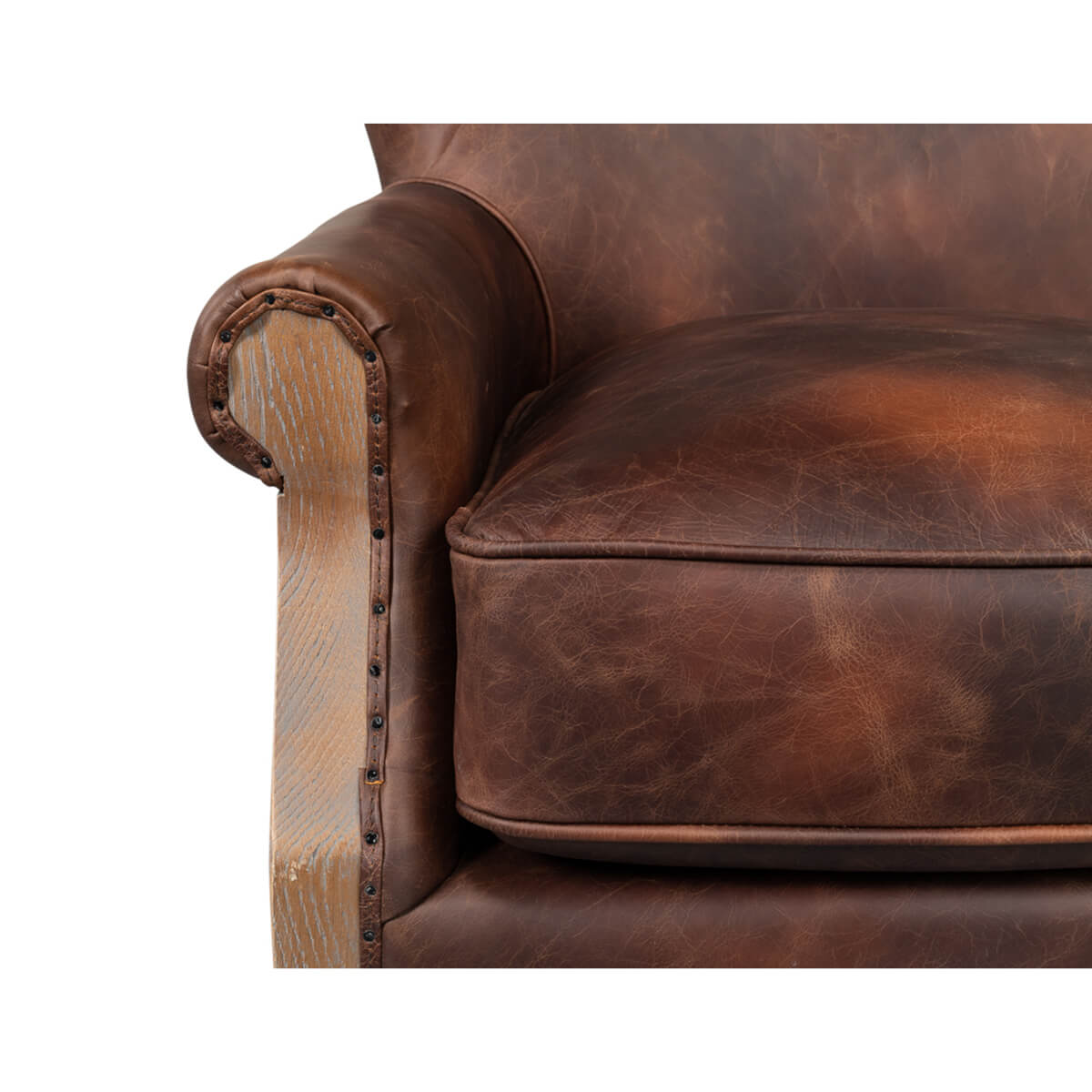 Front arm detail of club chair with leather and studs.