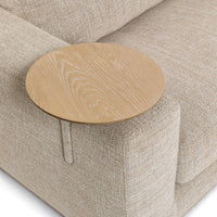 Overhead detail of the round wood table mounted beside the beige sectional seat