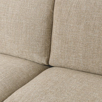 Close-up of beige sectional seat and back cushions showing the woven upholstery