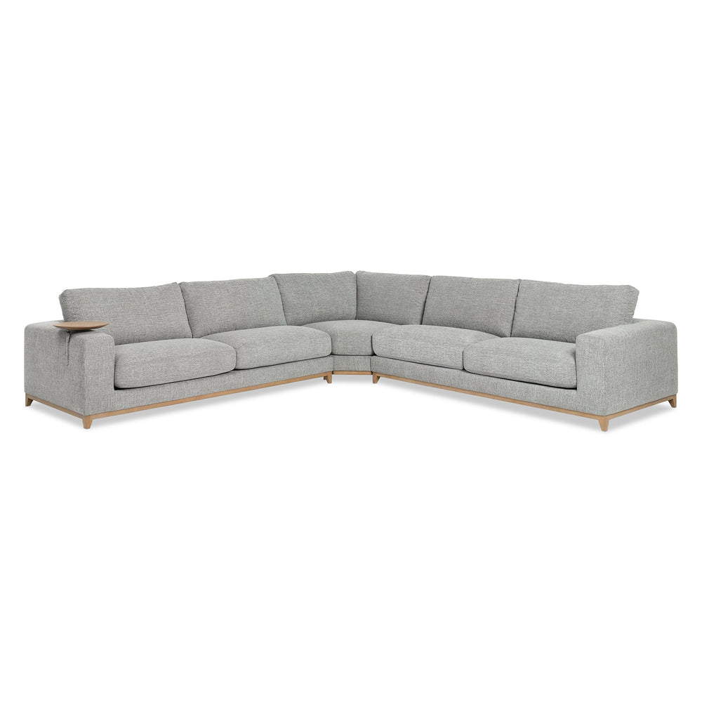 Angled front view of gray three-piece sectional with a wood base and round table at the arm
