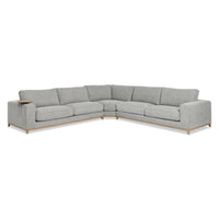 Angled front view of gray three-piece sectional with a wood base and round table at the arm