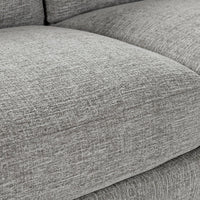 Close-up of gray sectional seat cushions showing the woven fabric and stitched edges