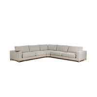 Angled front view of sand three-piece sectional with a wood base and round table at the arm