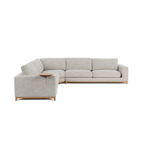 Angled view of sand sectional showing its arm-side table, broad cushions and wood base