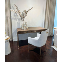 Desk in room setting with chair and decorative items.