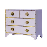 Lavender dresser with gold accents and ornate knobs.