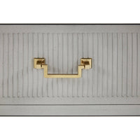 Close-up of gold handle on bedside chest.
