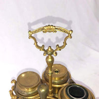 Close-up of brass Standish decorative handle and lids.