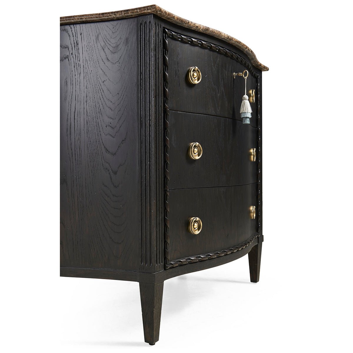Side angle of black marble top chest, detailed carvings.