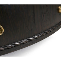 Textured wood detail of ebonized marble top chest.