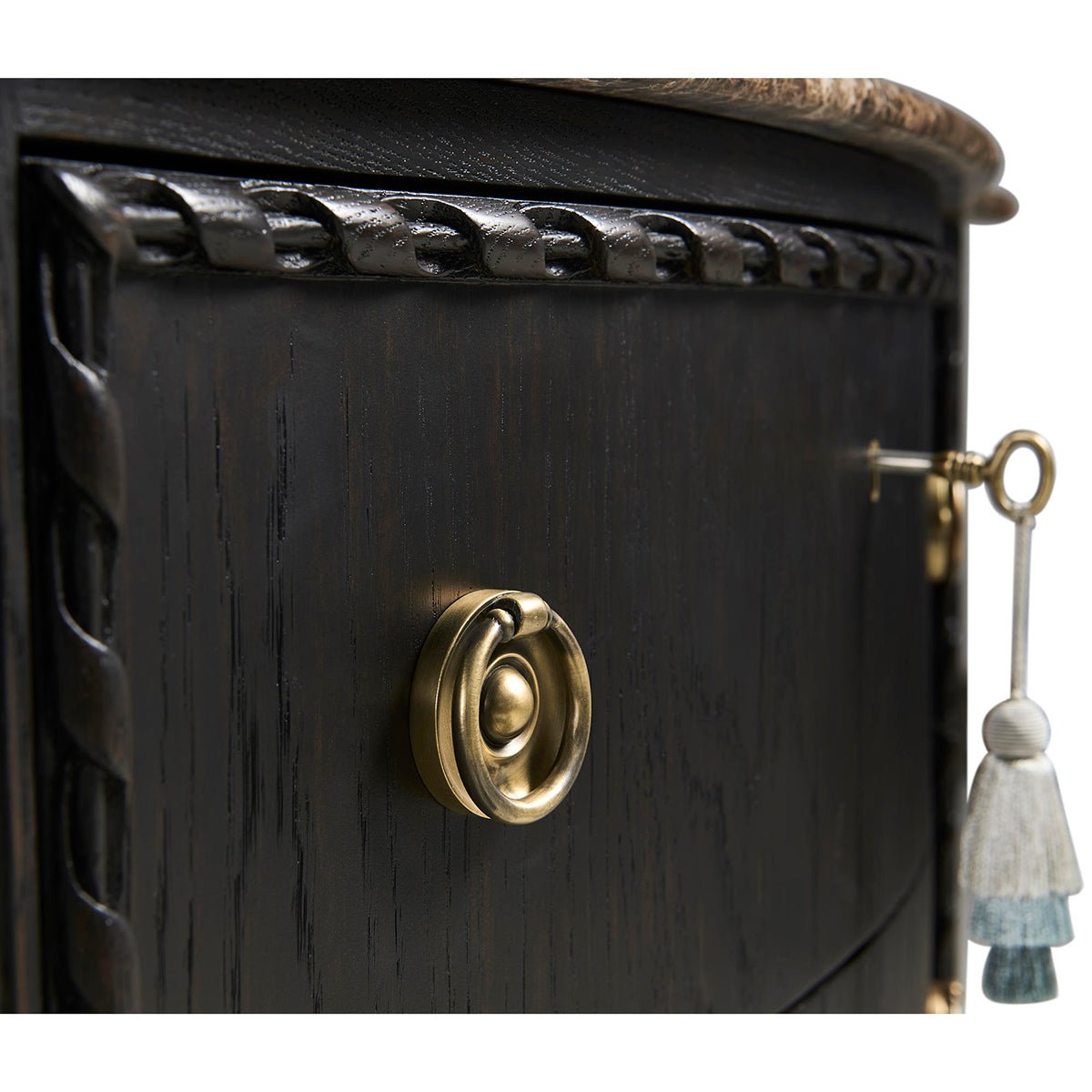 Brass handle detail on ebonized marble top chest.