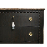 Brass hardware and tassel on ebonized marble chest.