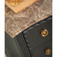 Close-up of marble top edge on ebonized chest.