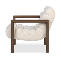 Side view of the Ivory Fleece chair with a curved channelled seat and open wood frame