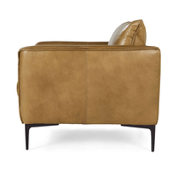 Side view of adobe tan leather club chair, showing its curved arm and slim black legs