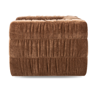Side view of the Bronze chair showing ruched upholstery in three horizontal bands