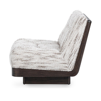 Side view of the Cocoa Cream chair's sloping upholstered back and walnut shell