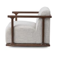 Side view of the ivory swivel chair showing its rounded wood arms and lower frame