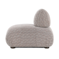 Side view of the armless chair showing its rounded seat and compact back cushion