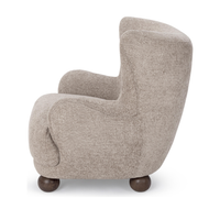 Side view of the Mushroom Taupe wingback chair with a curved back and rounded arm