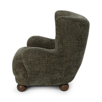 Side view of the Winter Fir wingback chair with a curved back and rounded arm