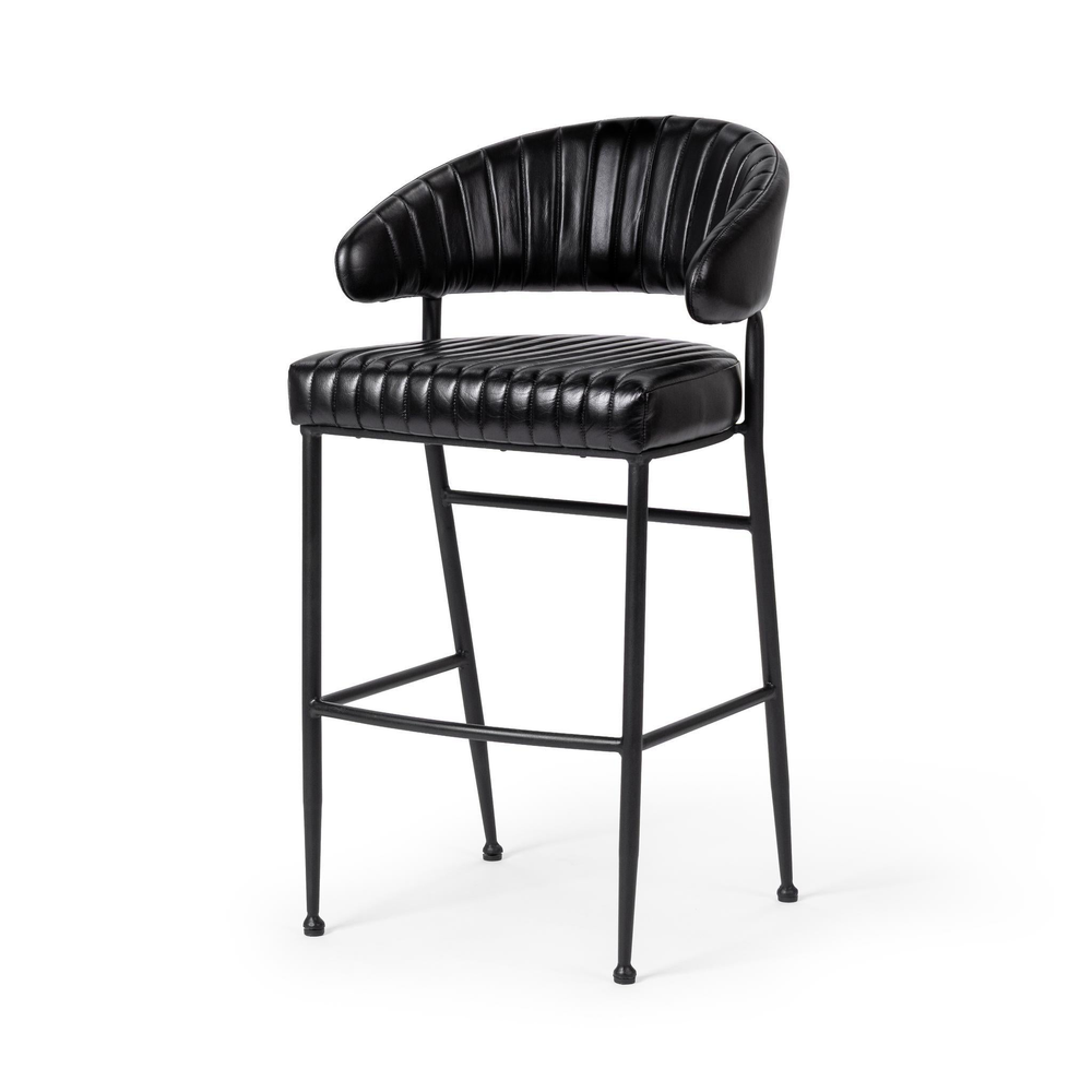 Fluted black leather bar stool in a three-quarter front view, showing the curved back and iron footrest