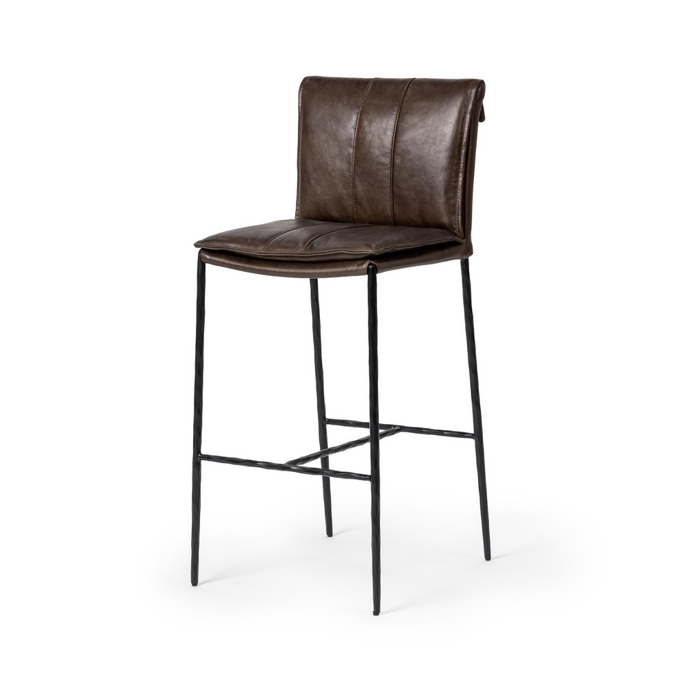 Slim-frame dark brown leather bar stool in a three-quarter front view, showing the stitched seat and slender iron legs